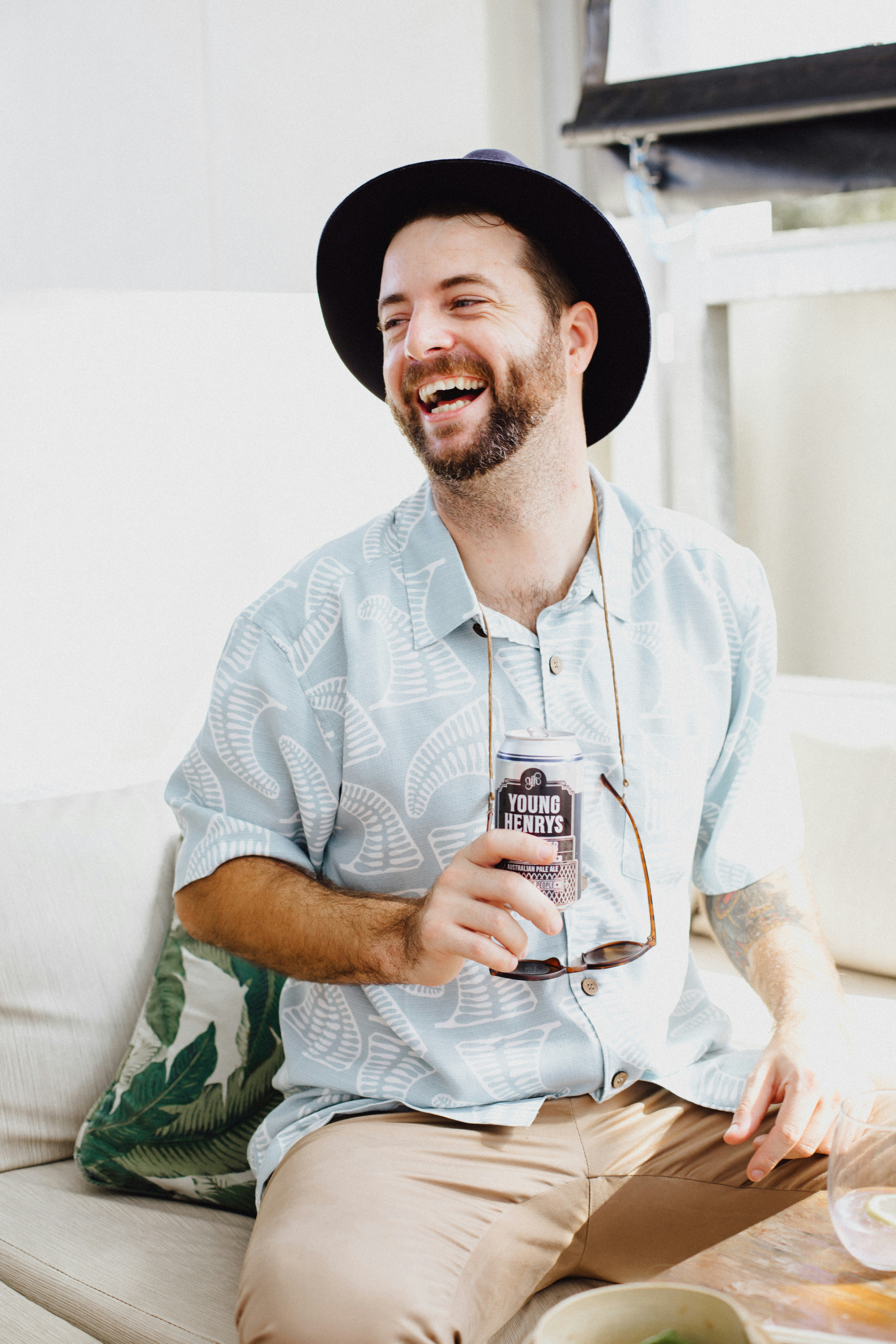 man in white and blue stripe button up shirt wearing black hat